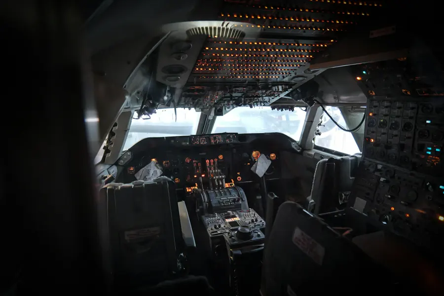 Boeing 747 flight deck with illuminated instruments and overhead switches